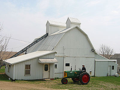 Wayne with the Oliver 77 in front of the Paul's Grains corn crib.