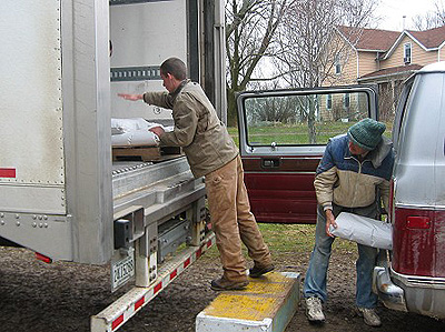 Joseph and Wayne load the 25# bags into the UNFI semi.